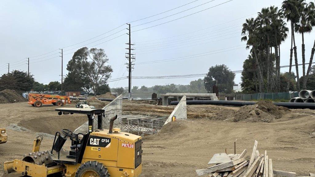 A yellow tractor in a construction site

Description automatically generated