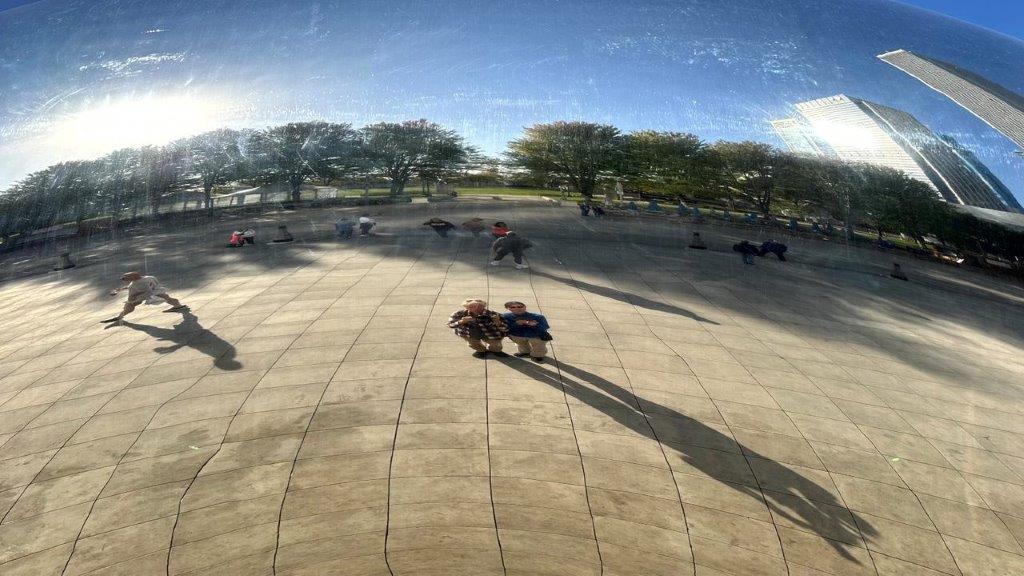 A group of people sitting on a stone surface

Description automatically generated