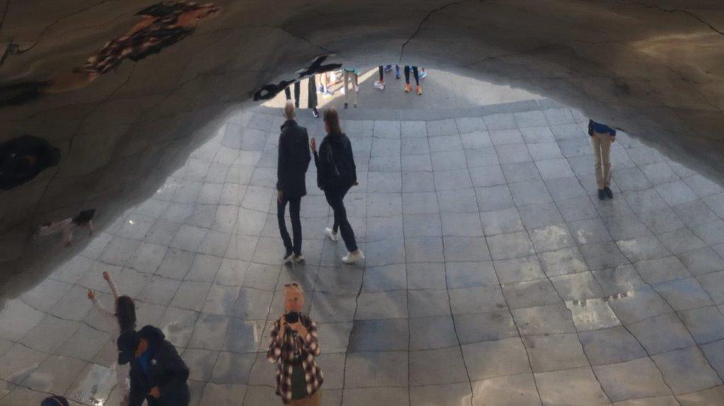 A group of people walking in a tunnel

Description automatically generated