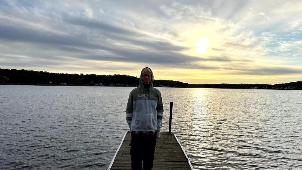 A person standing on a dock

Description automatically generated