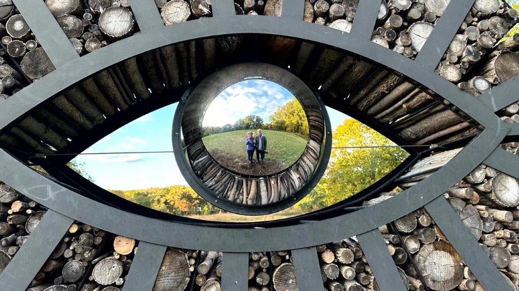 A reflection of a couple in a eye

Description automatically generated