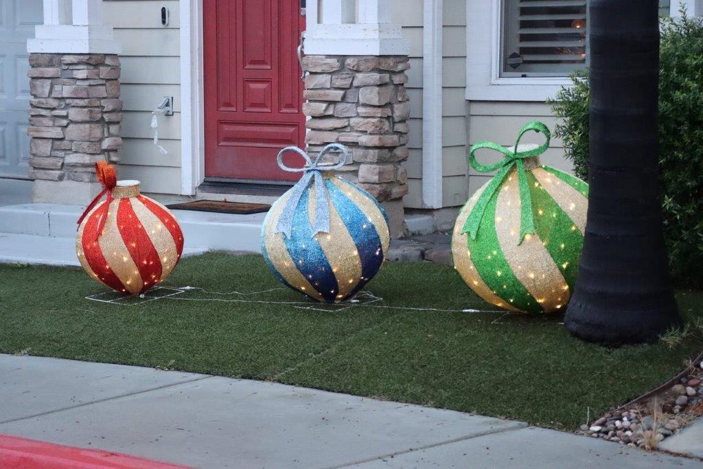 A group of christmas decorations on grass

Description automatically generated