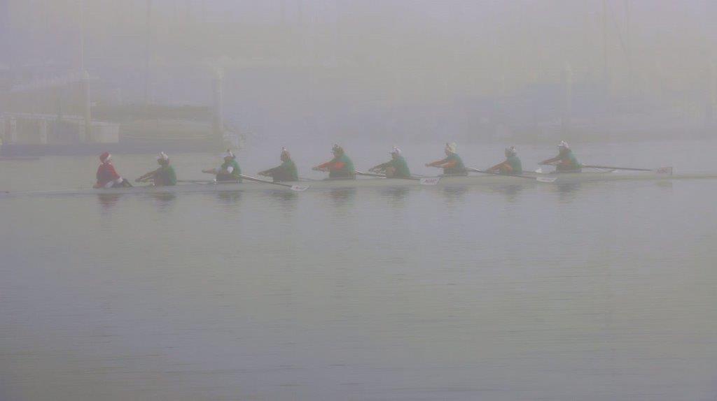 A group of people rowing on a river

Description automatically generated