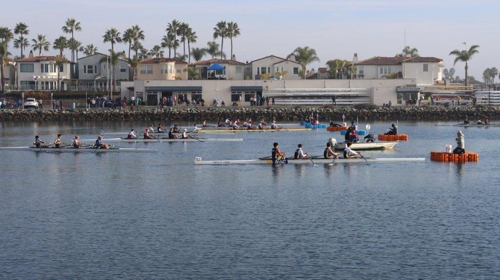 Long shot of a group of people rowing

Description automatically generated