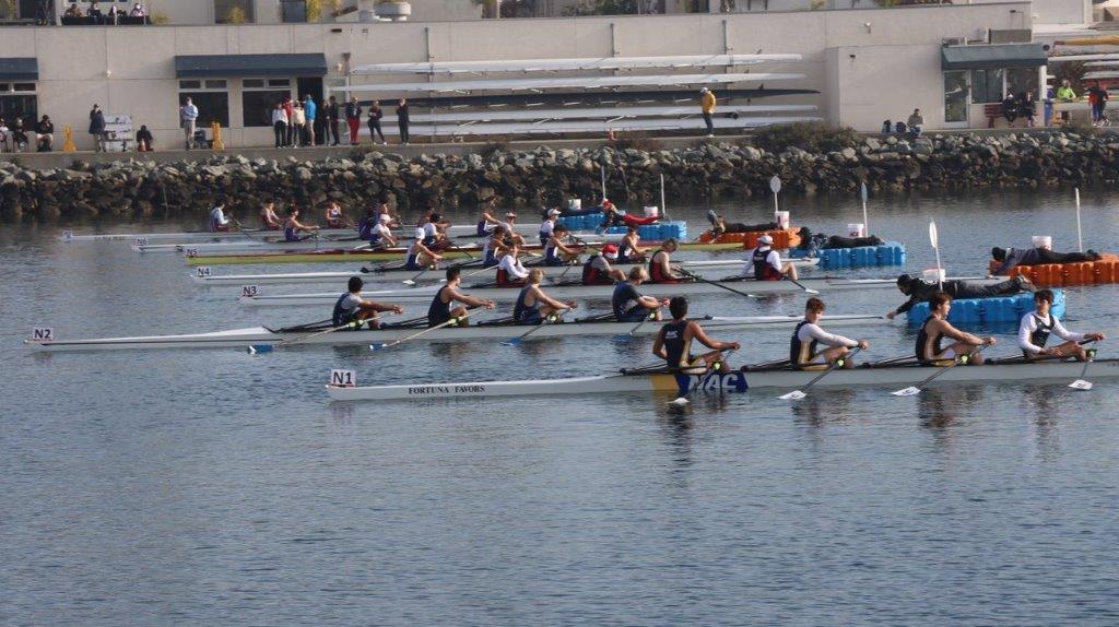 A group of people rowing on the water

Description automatically generated