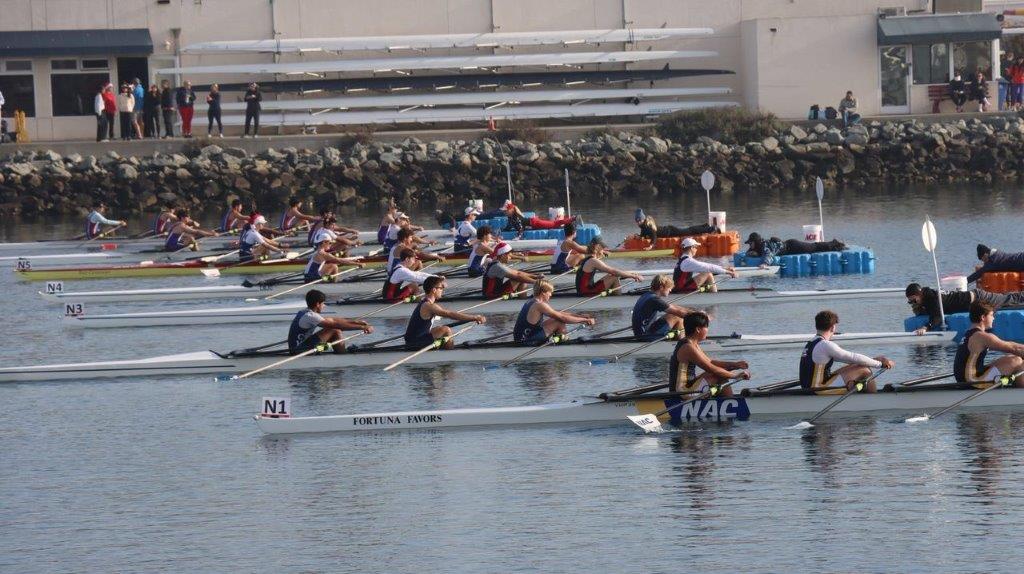 A group of people rowing on a river

Description automatically generated