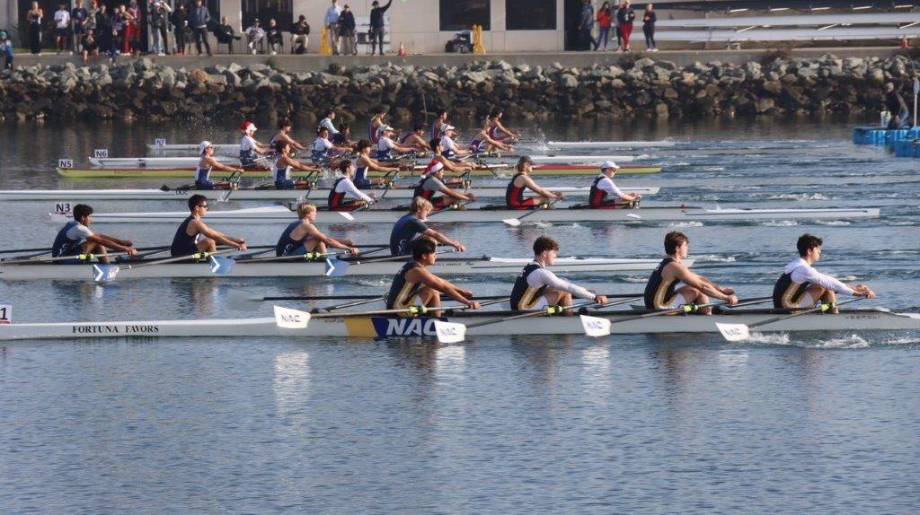 A group of people rowing on a river

Description automatically generated