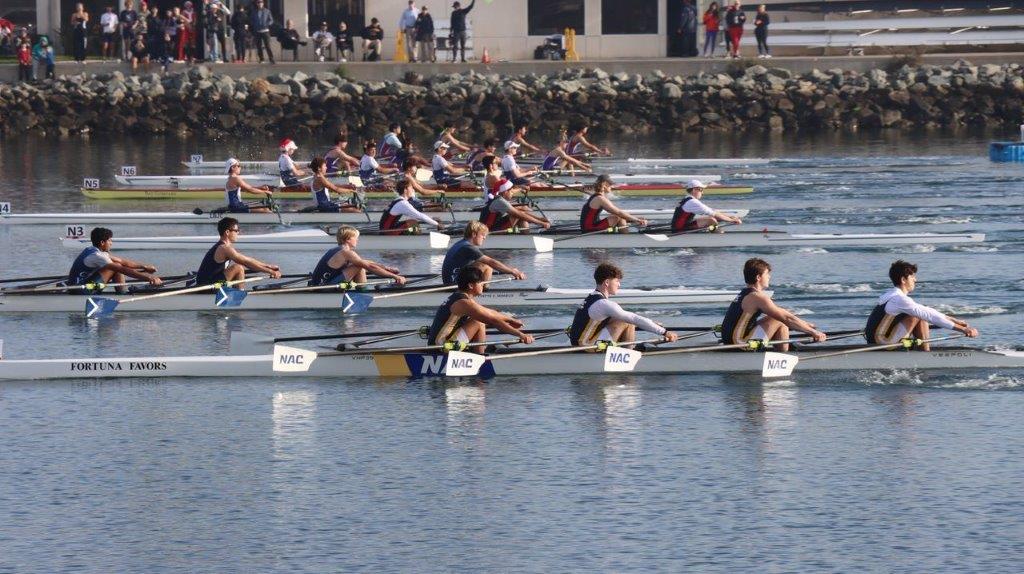 A group of people rowing on the water

Description automatically generated