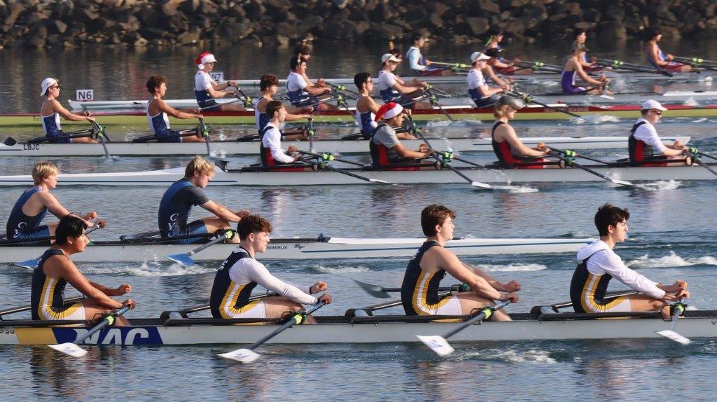 A group of people rowing on a river

Description automatically generated