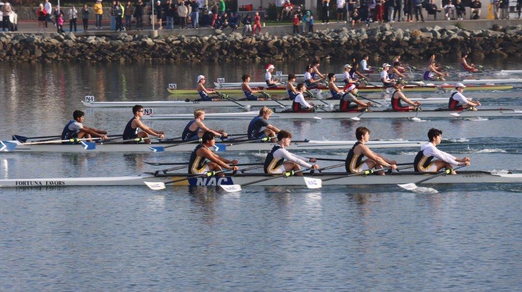 A group of people rowing on a river

Description automatically generated