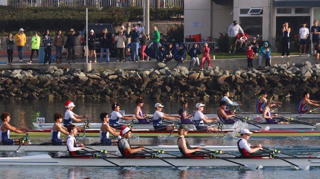 A group of people rowing on water

Description automatically generated