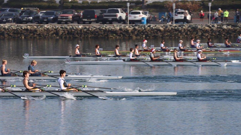 A group of people rowing on a river

Description automatically generated