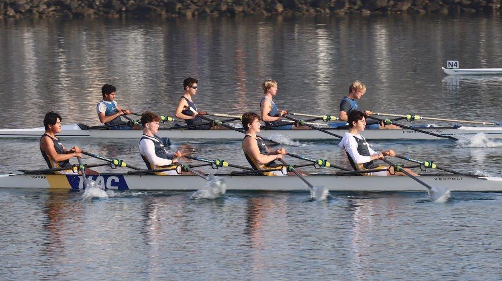 A group of people rowing on a river

Description automatically generated