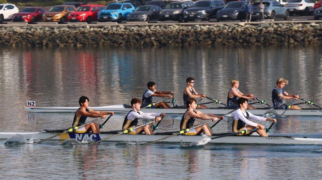 A group of people rowing on a river

Description automatically generated