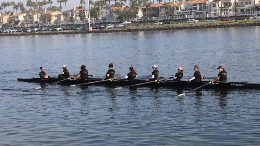 A group of people rowing a boat

Description automatically generated