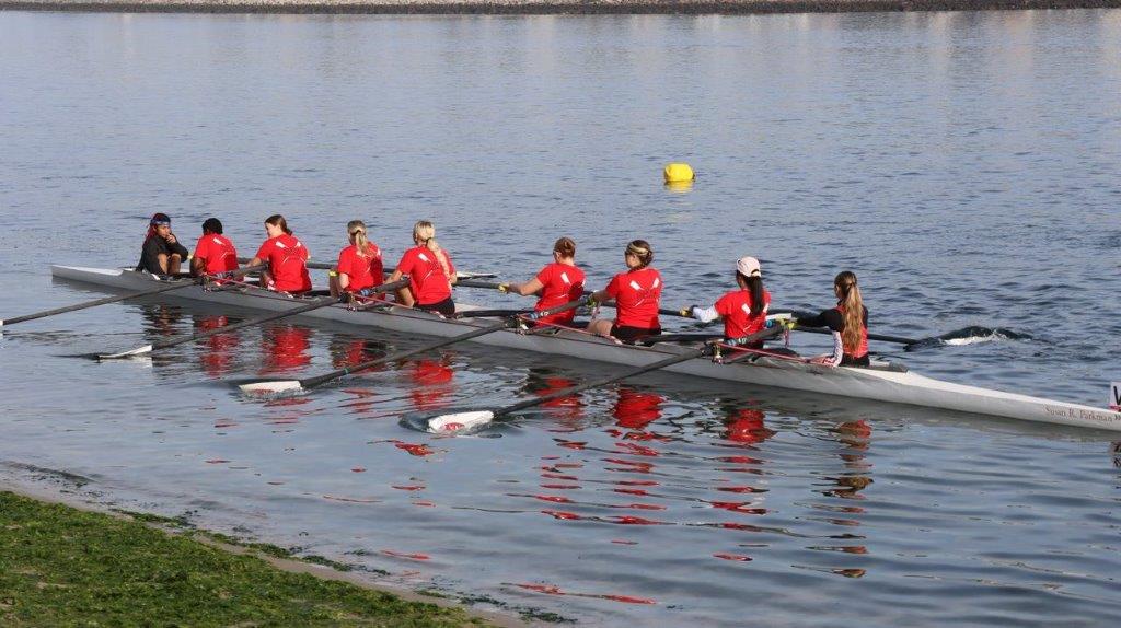 A group of people rowing a boat

Description automatically generated