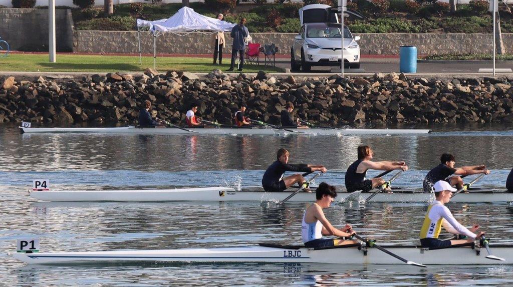 A group of people rowing on a lake

Description automatically generated