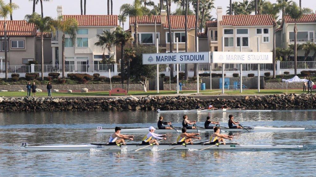 A group of people rowing on the water

Description automatically generated