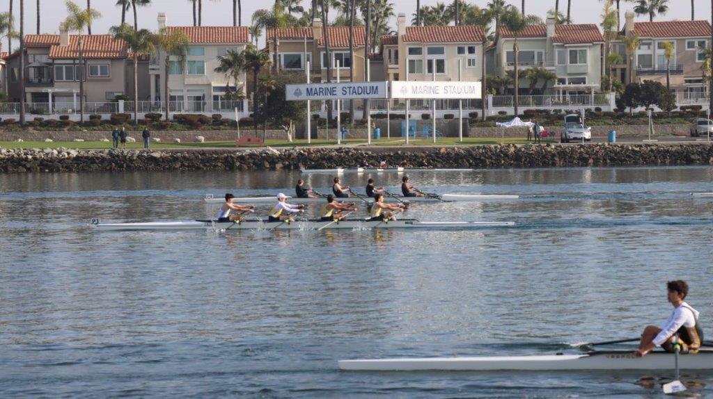 A group of people rowing on the water

Description automatically generated