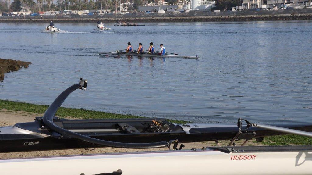 A group of people rowing a boat

Description automatically generated