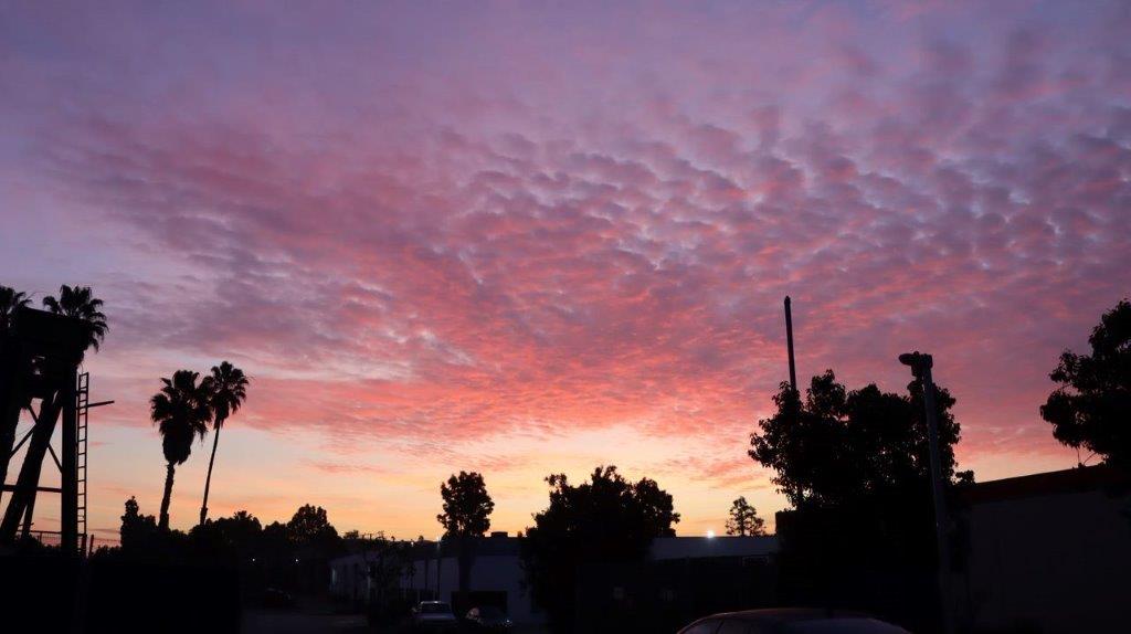 A pink and purple sky with clouds

Description automatically generated