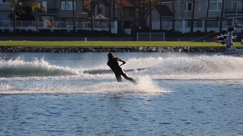 A person water skiing on a lake

Description automatically generated