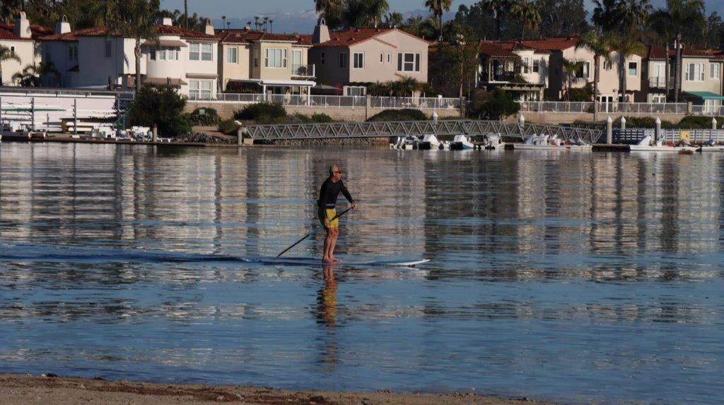 A person on a paddle board in the water

Description automatically generated