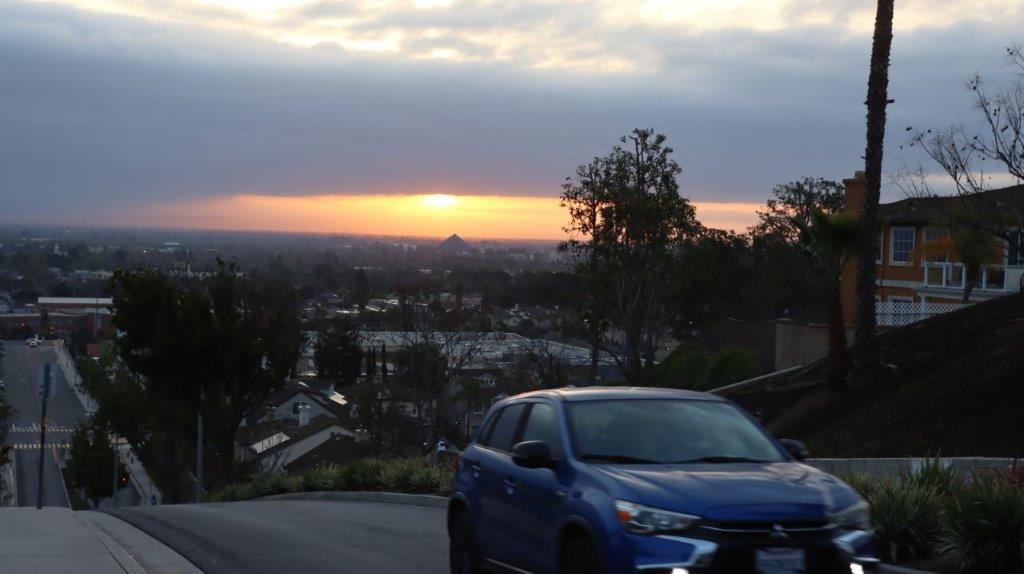 A car on a road with trees and a sunset

AI-generated content may be incorrect.