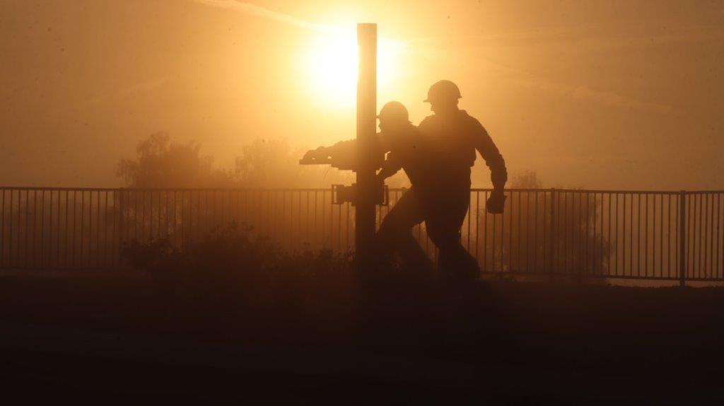 A silhouette of men walking on a pole

AI-generated content may be incorrect.