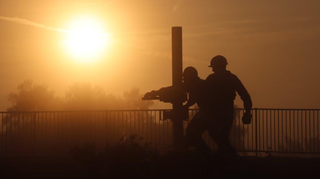 A silhouette of men walking on a bridge

AI-generated content may be incorrect.