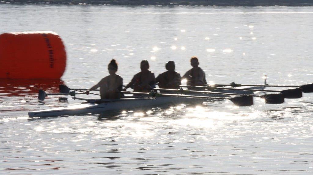 A group of people rowing a boat

Description automatically generated