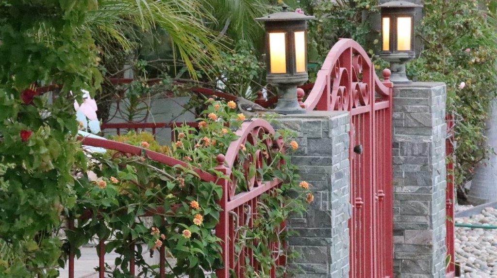 A red gate with a lamp post and a red gate

Description automatically generated