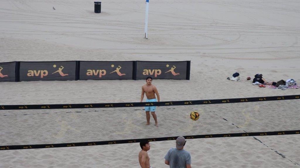 A group of people playing volleyball

Description automatically generated