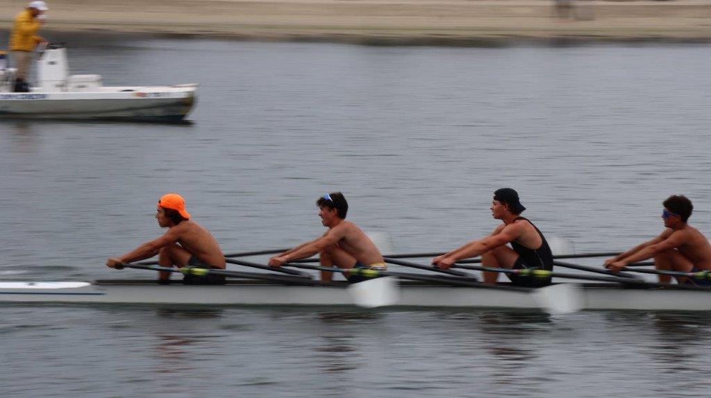A group of men rowing on a boat

Description automatically generated