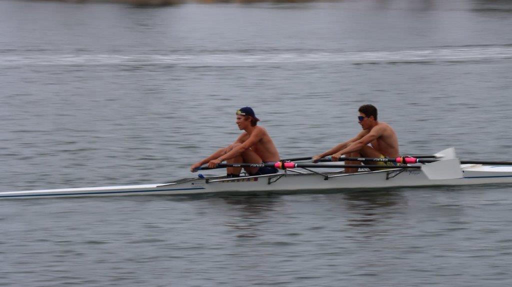 A group of men rowing on a boat

Description automatically generated