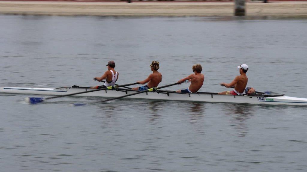 A group of men rowing on a river

Description automatically generated
