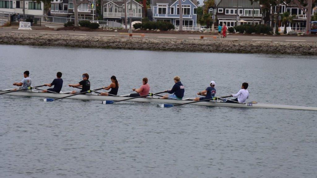 A group of people rowing on a river

Description automatically generated