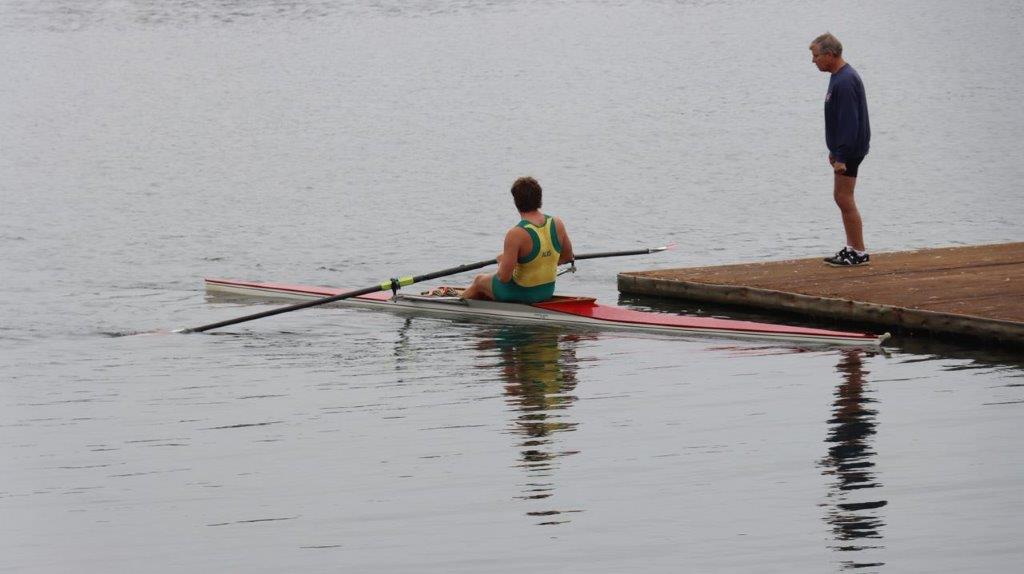 A person rowing a boat on the water

Description automatically generated