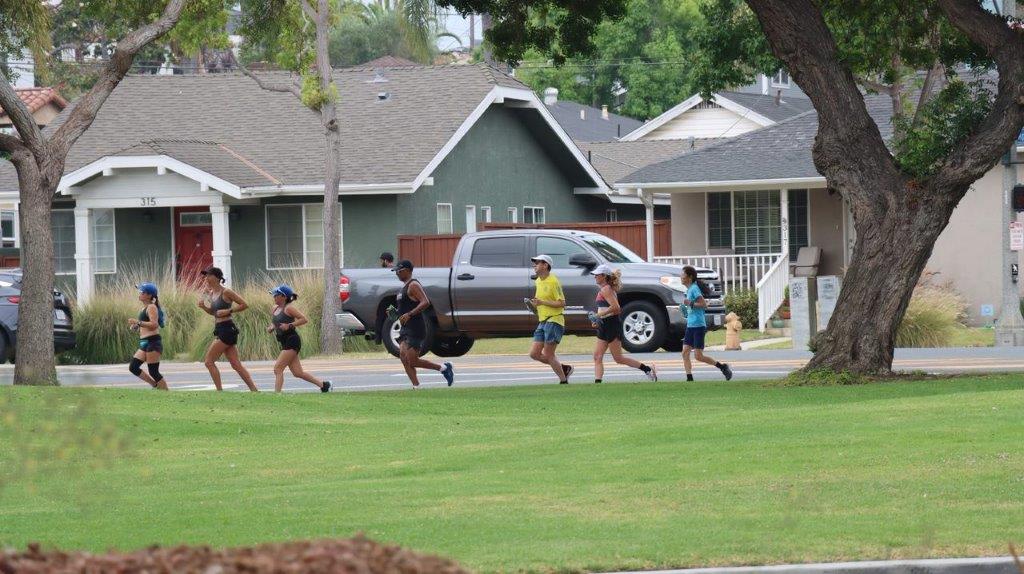 A group of people running on a street

Description automatically generated