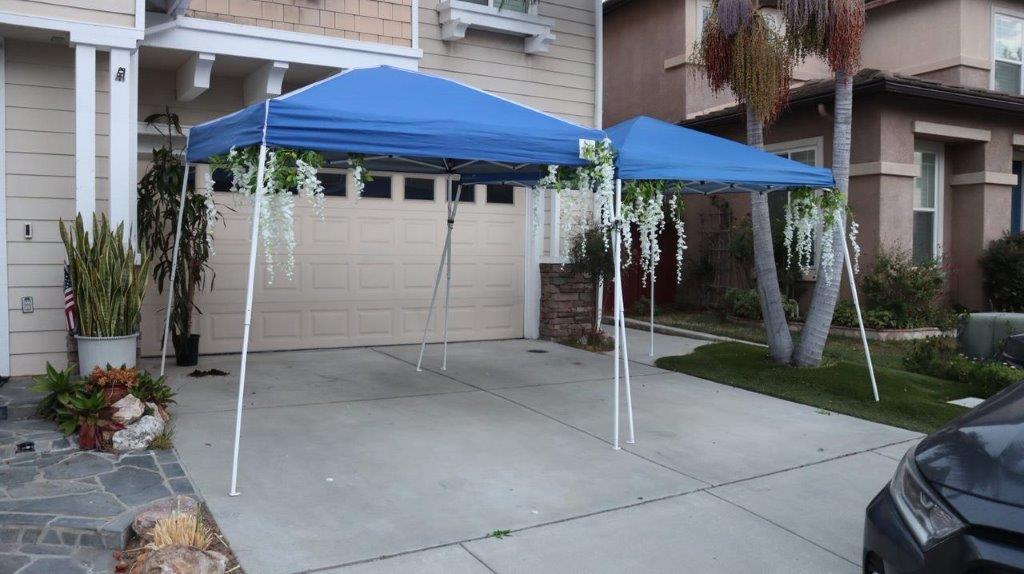 A blue tent in front of a house

Description automatically generated