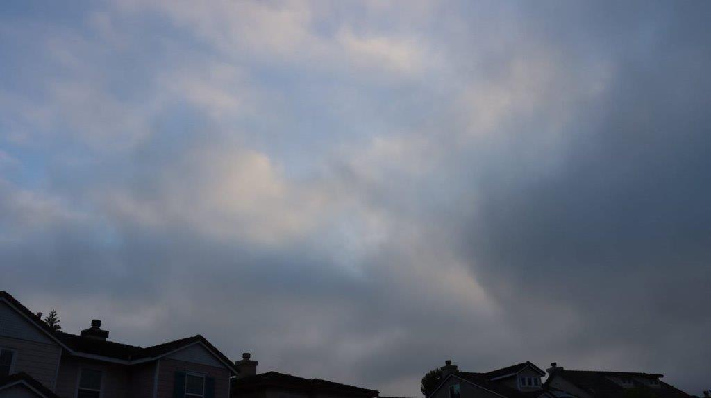 A cloudy sky over a neighborhood

Description automatically generated