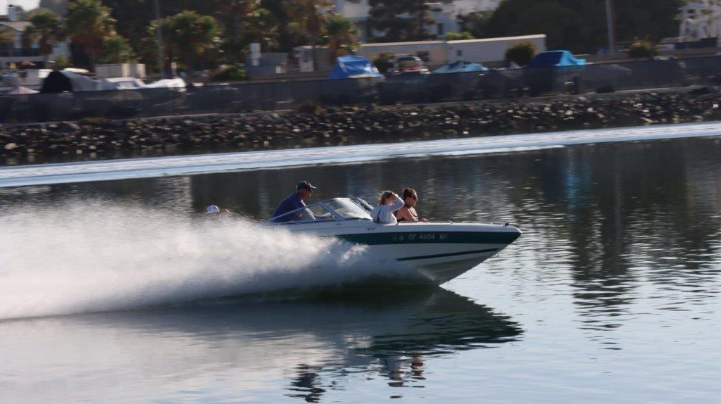 A group of people on a speedboat

Description automatically generated