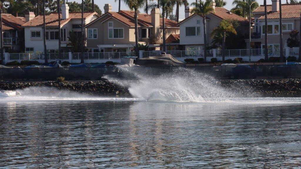 Water splashing water in front of houses

Description automatically generated