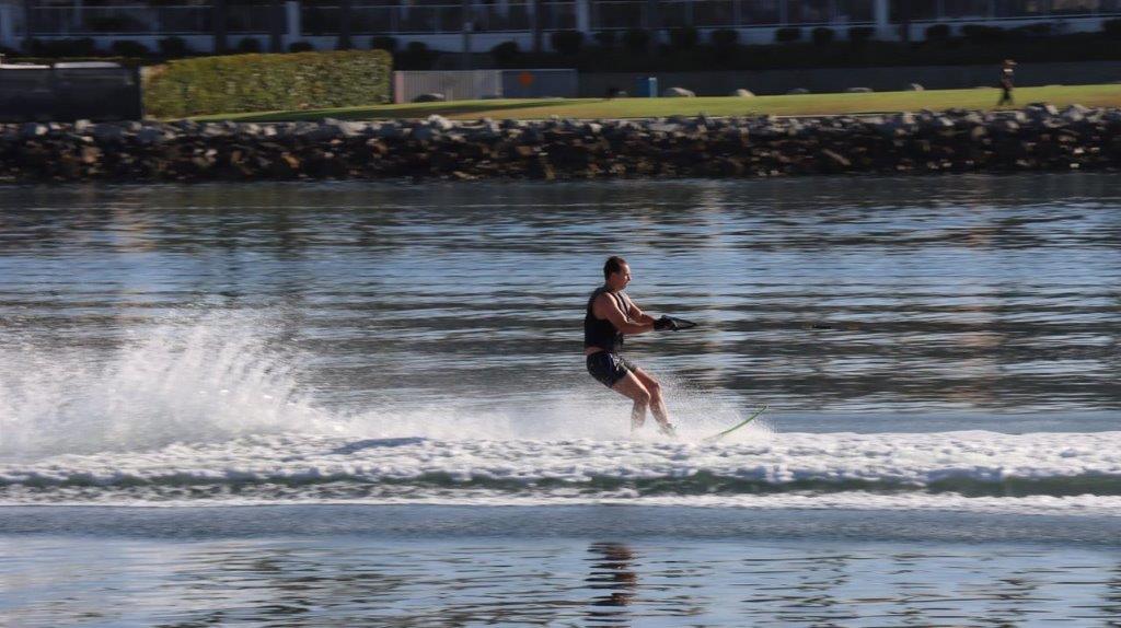 A person water skiing on a lake

Description automatically generated