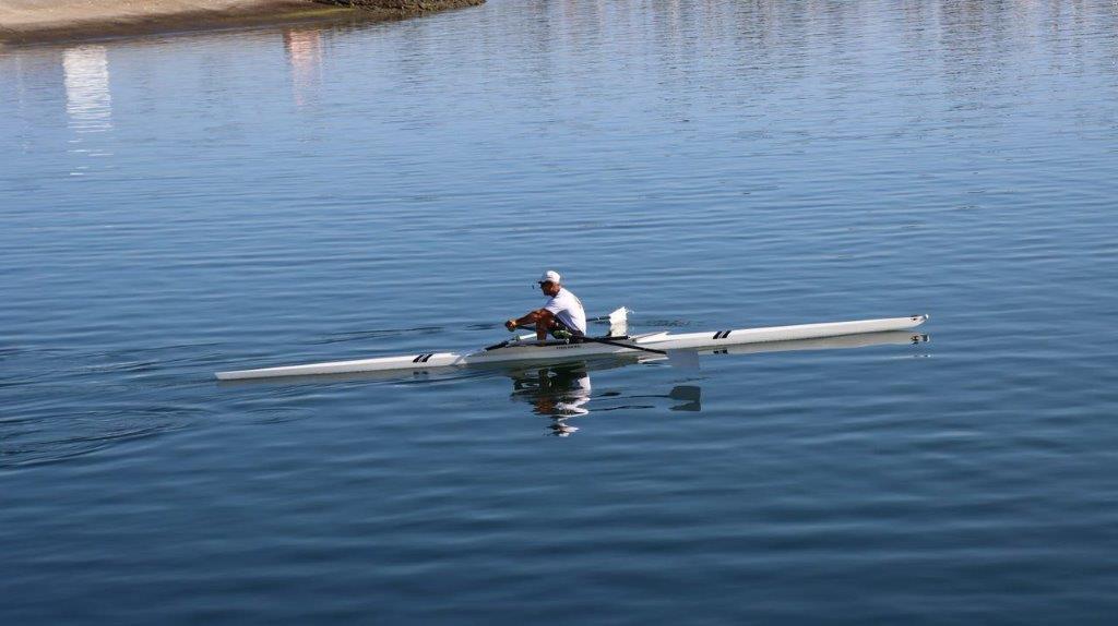 A person in a boat on a lake

Description automatically generated