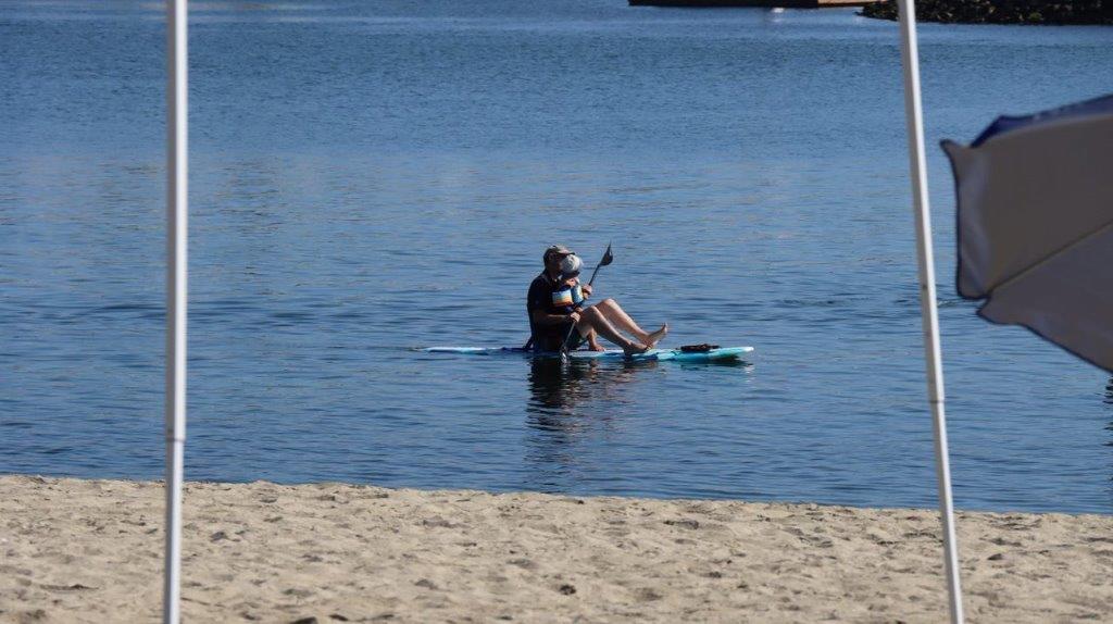 A person on a paddle board in the water

Description automatically generated