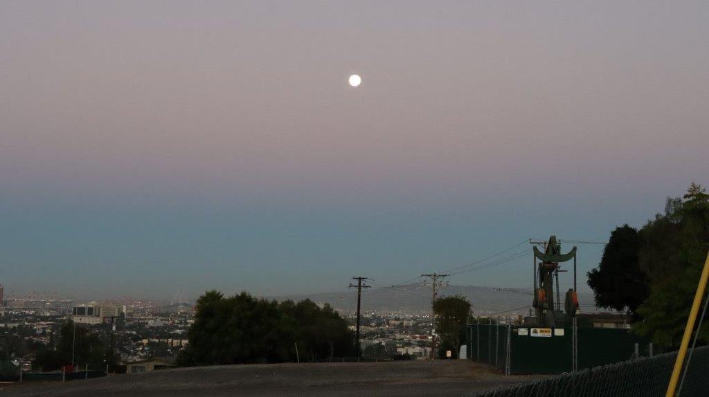 A full moon over a city

Description automatically generated