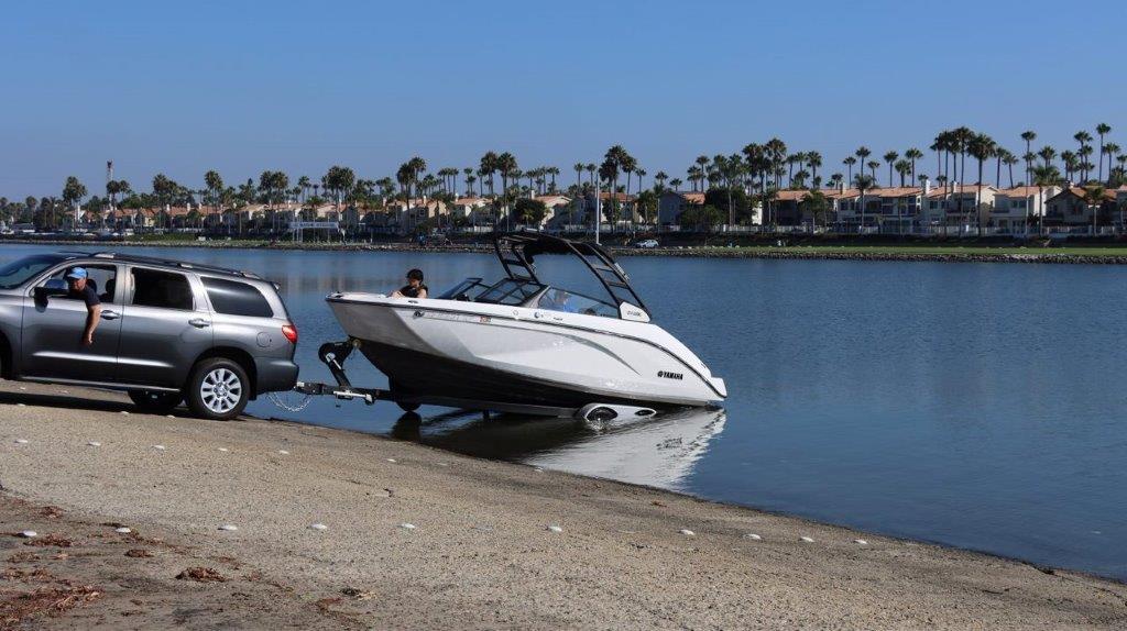 A boat on a trailer on a body of water

Description automatically generated