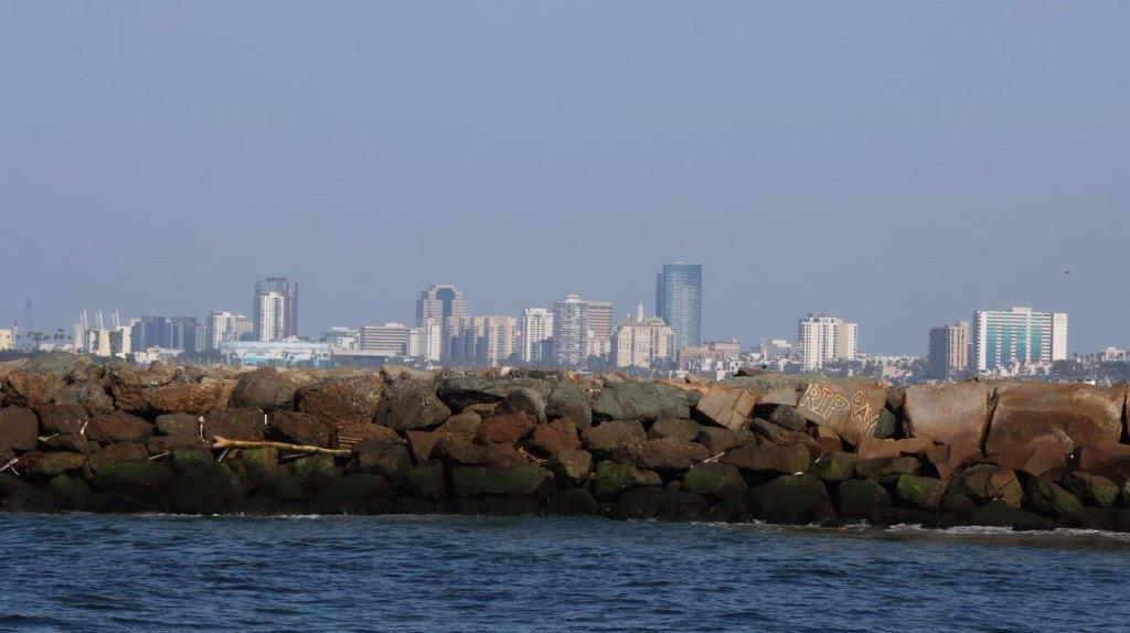 A city skyline from a rocky wall

Description automatically generated with medium confidence