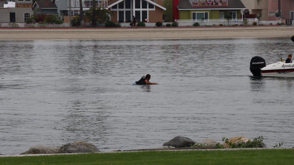 A person swimming in a body of water

Description automatically generated